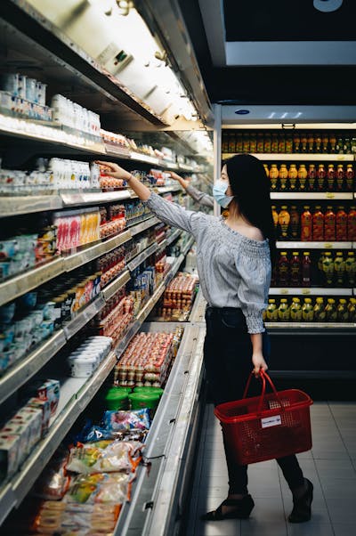 Supermarket shopping basket in a grocery aisle