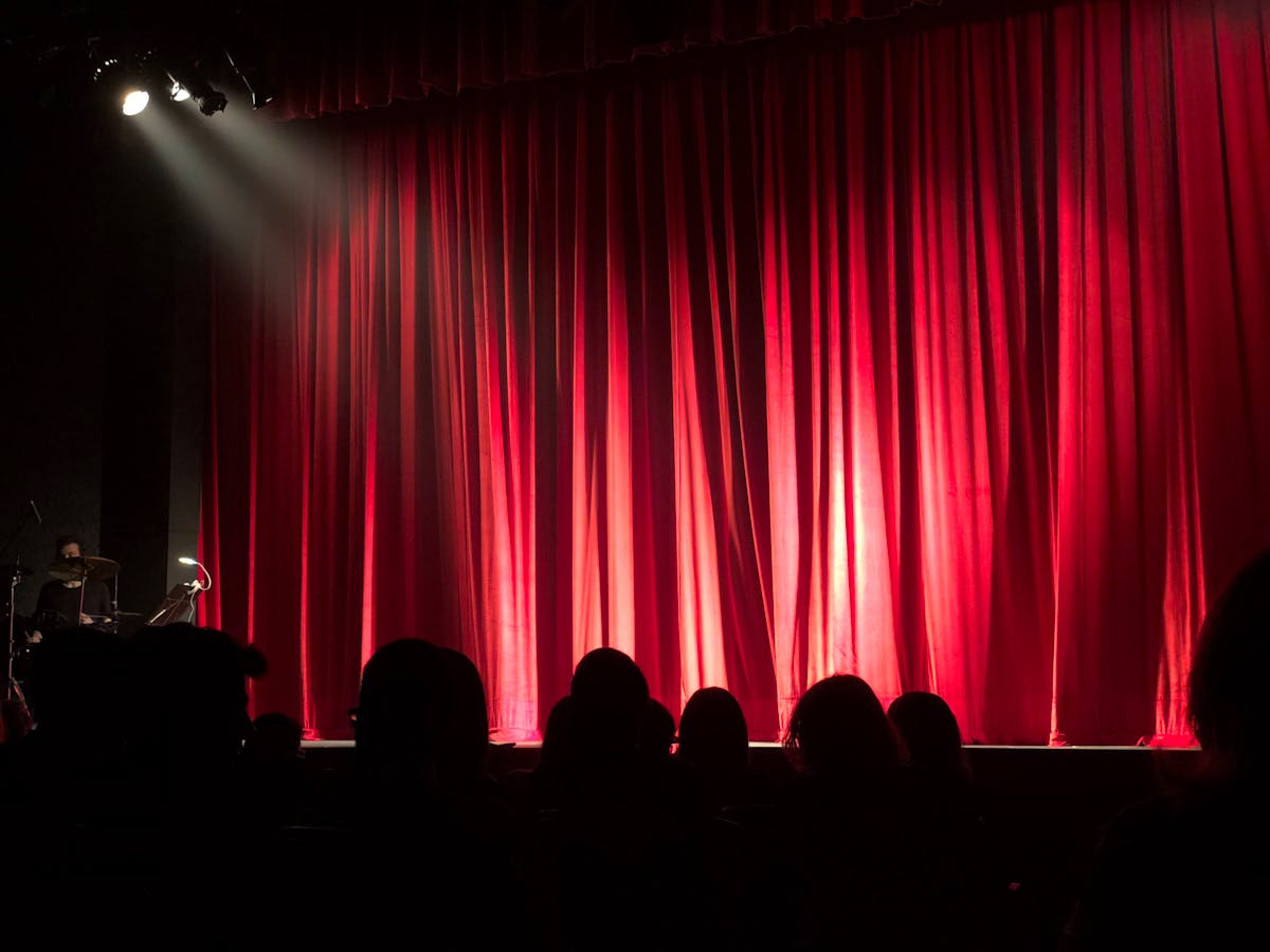 Stand-up comedian performing on stage under spotlight