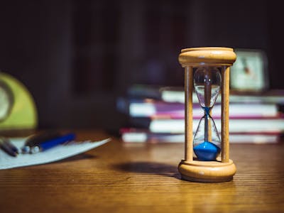 timer and notebook on desk for productivity