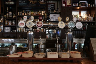 cosy pub interior with bar and stools