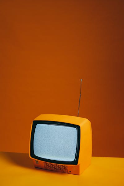 Group of people laughing while watching TV together