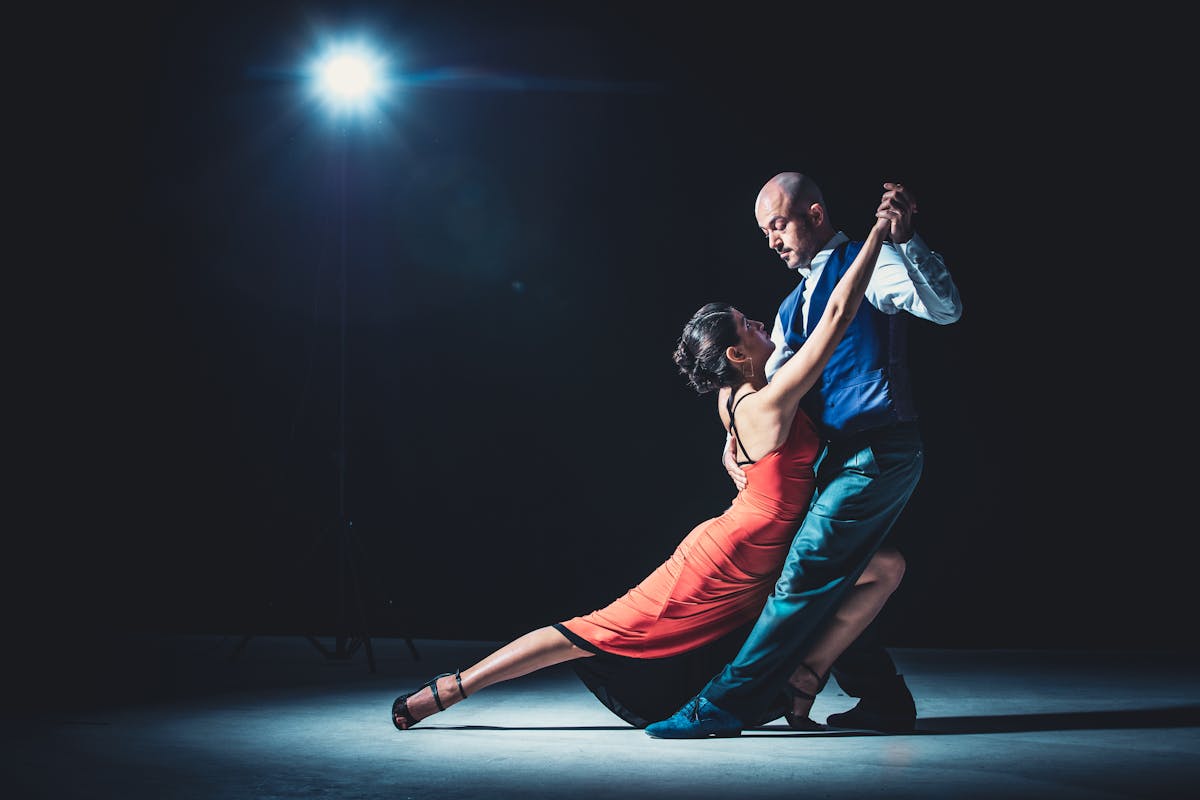 Elegant ballroom dance performance under stage lights